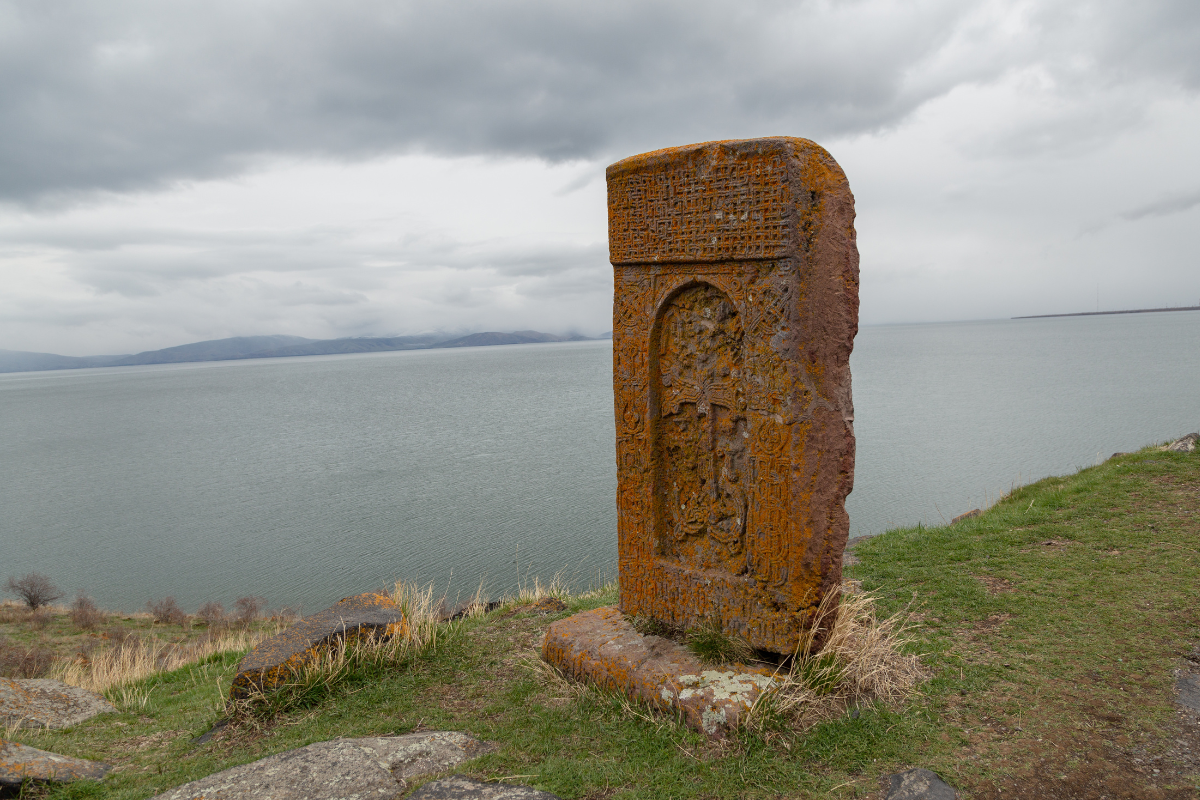 Armenian khachkar set against the backdrop of Lake Sevan, Gegharkunik region.